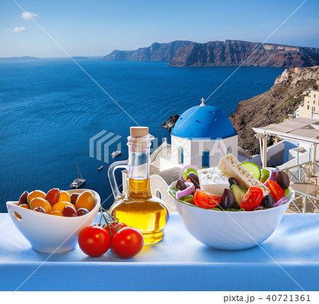Greek salad and Oia on Santorini island in Greece Greek salad and Oia on Santorini island in Greece 40721361