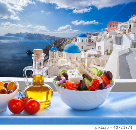 Greek salad and Oia on Santorini island in Greece Greek salad and Oia on Santorini island in Greece 40721371