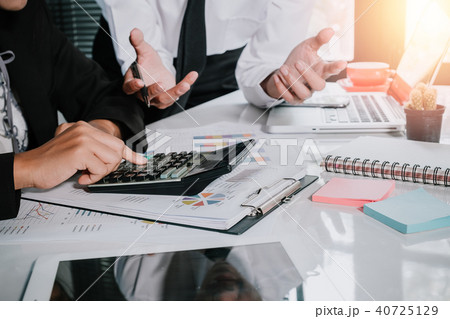 Business team using calculator and laptop computer 40725129