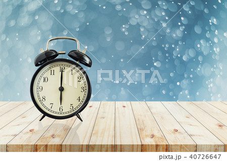 Alarm clock on wood table with bokeh background 40726647