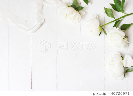 Styled stock photo. Feminine wedding table composition with white peonies flowers and silk ribbon on 40726971