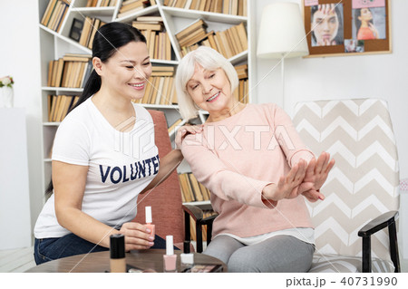 Vigorous senior woman admiring manicure 40731990