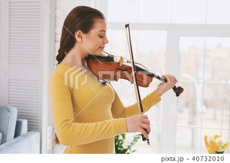 Attentive female person practicing new work Attentive female person practicing new work 40732010