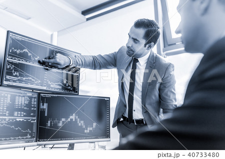 Stock brokers trading online in corporate office. 40733480