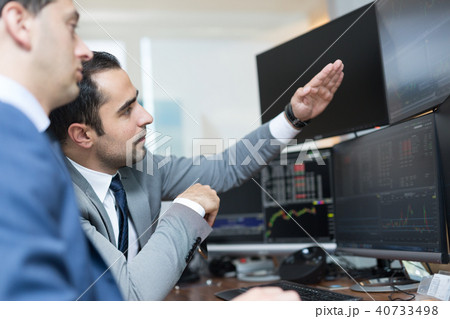 Stock brokers looking at computer screens, trading online. 40733498