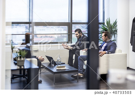 Business people sitting at working meeting in modern corporate office. Business people sitting at working meeting in modern corporate office. 40733503