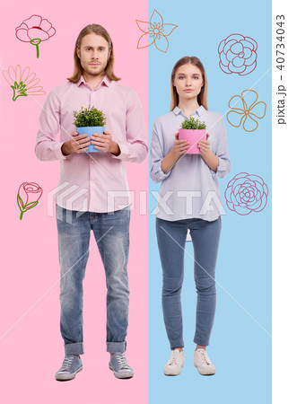 Skilled gardeners looking confident while standing with flower pots 40734043