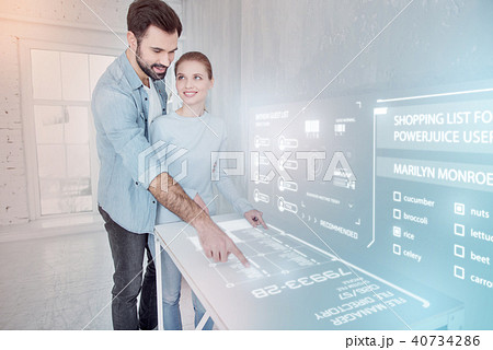 Young web designer pointing to the futuristic device Young web designer pointing to the futuristic device 40734286