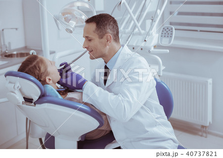 Attractive male dentist regarding oral cavity Attractive male dentist regarding oral cavity 40737821