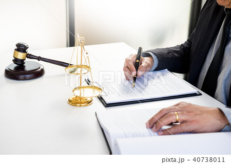 lawyer judge reading writes the document in court at his desk lawyer judge reading writes the document in court at his desk 40738011