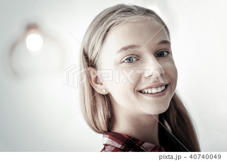 Satisfied confident girl standing and smiling. Satisfied confident girl standing and smiling. 40740049