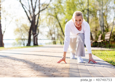 Pleasant aged woman starting to run 40740753