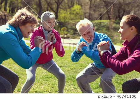 Joyful woman exercising with her friends Joyful woman exercising with her friends 40741100
