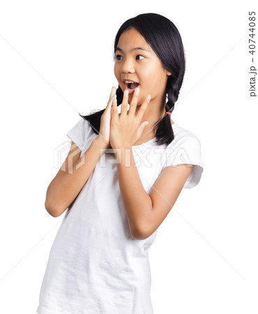 Portrait of young girl with hands over her mouth 40744085