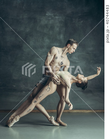 The young modern ballet dancers posing on gray studio background The young modern ballet dancers posing on gray studio background 40744483