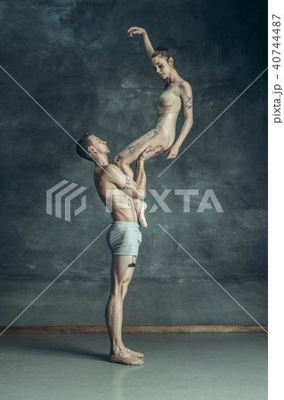 The young modern ballet dancers posing on gray studio background 40744487