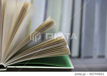 Open book, stack of hardback books on table. Top view. Open book, stack of hardback books on table. Top view. 40744601