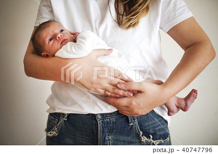 Young mother holding her newborn child. Young mother holding her newborn child. 40747796