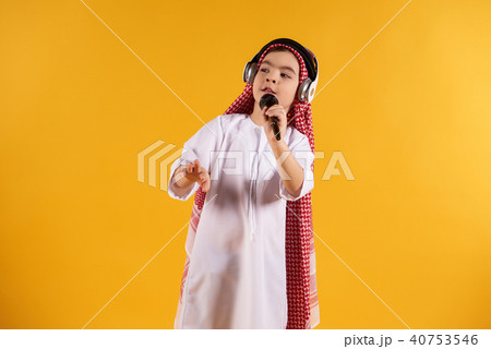 Arabian boy in keffiyeh with microphone  40753546