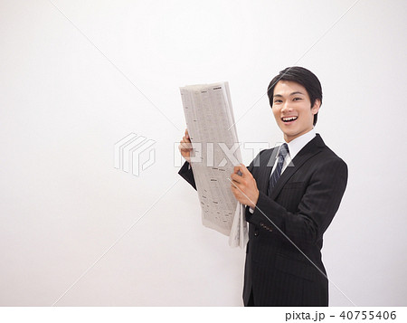 新聞の株式欄を見て笑うビジネスマン 新聞の株式欄を見て笑うビジネスマン 40755406