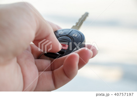 Man hold car remote control to lock, unlock 40757197