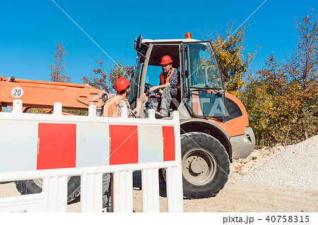 Construction worker starting road works on site 40758315