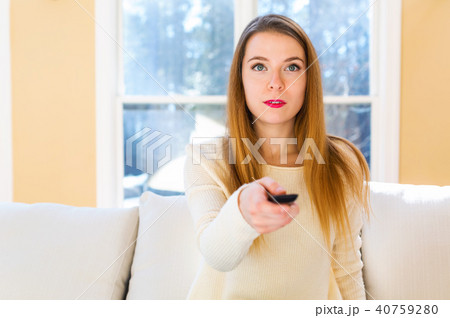 Young woman watching TV Young woman watching TV 40759280
