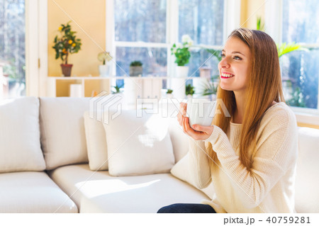 Happy young woman drinking coffee 40759281