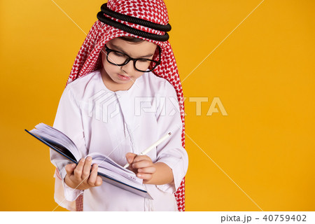 Arab happy boy with glasses makes notes Arab happy boy with glasses makes notes 40759402