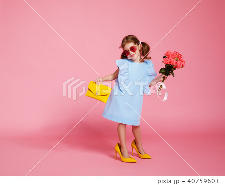 funny child girl in big mother's shoes funny child girl in big mother's shoes 40759603
