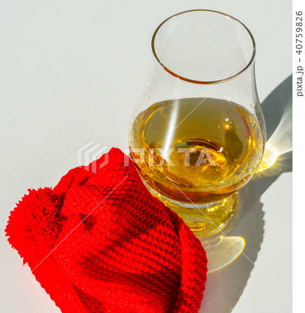 Single Malt Whiskey in a glass with a red cap 40759826