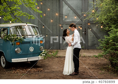 Merry happy young couple hugging near a retro bus Merry happy young couple hugging near a retro bus 40760899