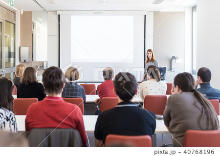 Woman giving presentation in lecture hall at university. Woman giving presentation in lecture hall at university. 40768196