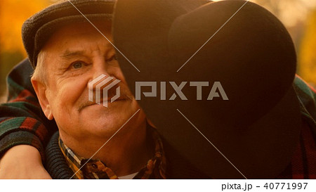 Young woman is hugging her father on the meeting in the autumn park 40771997