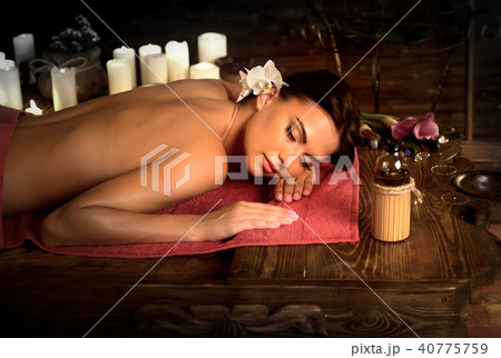 Massage of woman in spa salon. Luxary interior oriental therapy . Massage of woman in spa salon. Luxary interior oriental therapy . 40775759