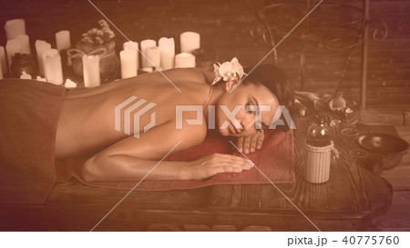 Massage of woman in spa salon. Luxary interior oriental therapy . 40775760