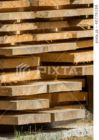 Stacked wooden boards are waiting for processing Stacked wooden boards are waiting for processing 40776199