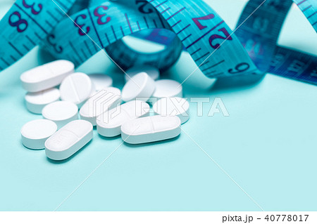 Pills spilling out of pill bottle 40778017