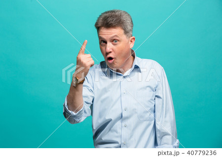 Beautiful male half-length portrait isolated on blue studio backgroud. The senior emotional Beautiful male half-length portrait isolated on blue studio backgroud. The senior emotional 40779236
