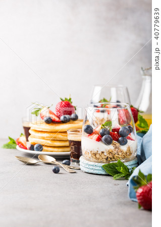 Breakfast with granola, pancakes and berries 40779639
