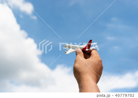 Hand of man holding a toy plane 40779702
