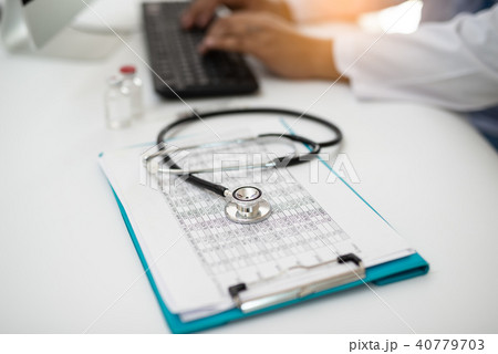 Stethoscope with Doctor working on desk computer 40779703