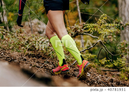 female runner in yellow compression socks female runner in yellow compression socks 40781931