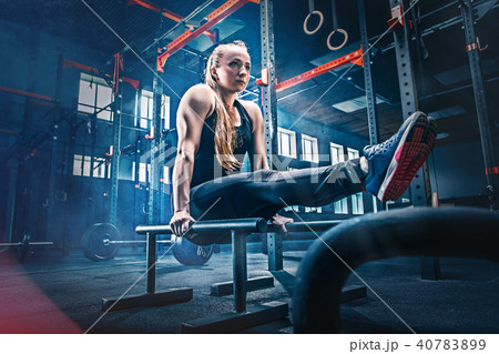 Concept: power, strength, healthy lifestyle, sport. Powerful attractive muscular woman at CrossFit Concept: power, strength, healthy lifestyle, sport. Powerful attractive muscular woman at CrossFit 40783899