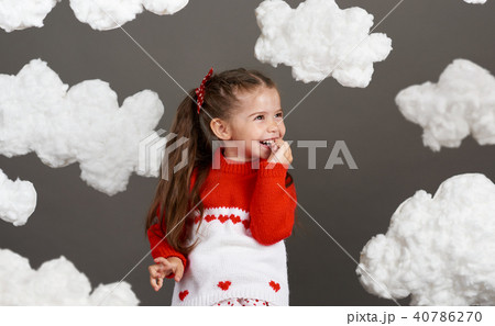 girl playing with clouds, dressed in red sweater 40786270