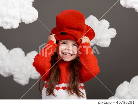 girl playing with clouds, dressed in red sweater girl playing with clouds, dressed in red sweater 40786291