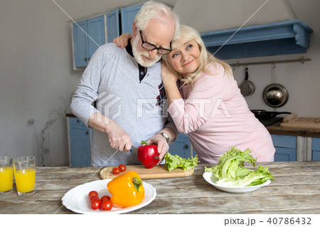 Senior couple cooking together. 40786432
