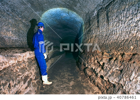 Man in dark old tunnel. Bastion passage under city 40786461