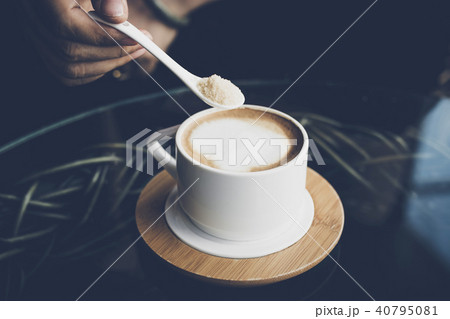 Woman hands with latte coffee on the table. 40795081