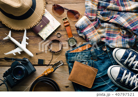 Travel accessories and costume on wooden floor 40797521